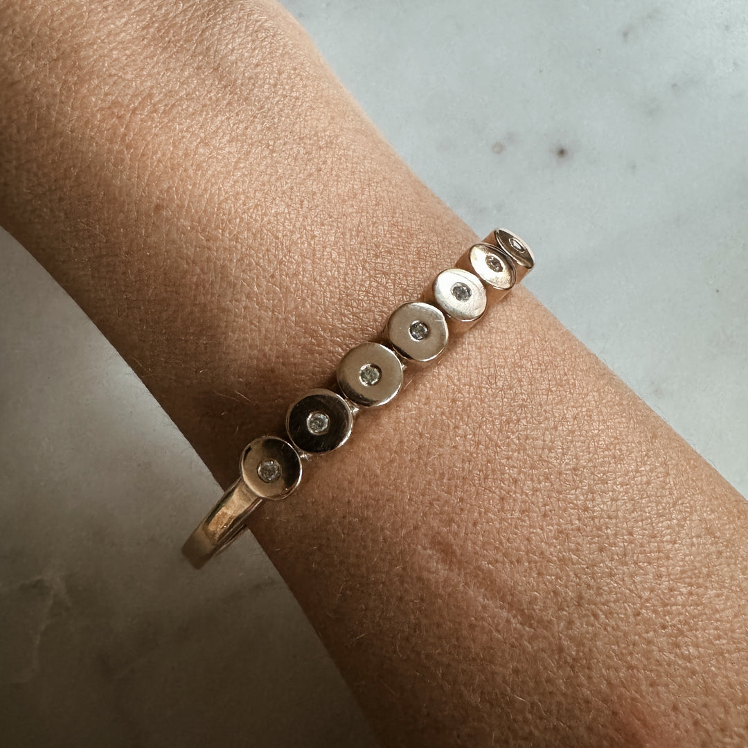 Woman Wears the MIMOSA Handcrafted Minimal Circle Stone Cuff with Diamonds