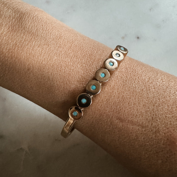 Woman Wears the MIMOSA Handcrafted Minimal Circle Stone Cuff with Turquoise