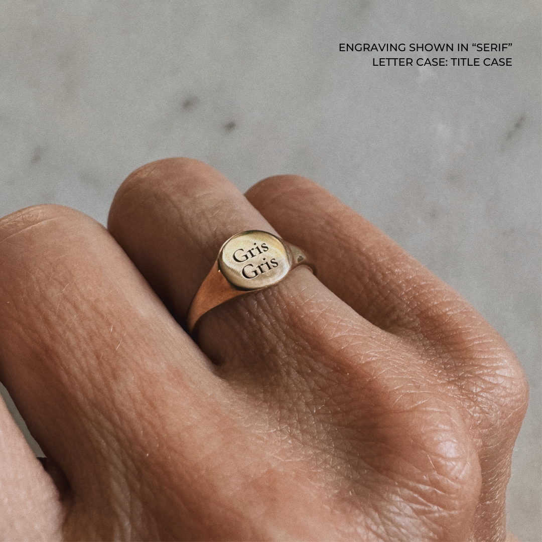A bronze signet ring with the the words &