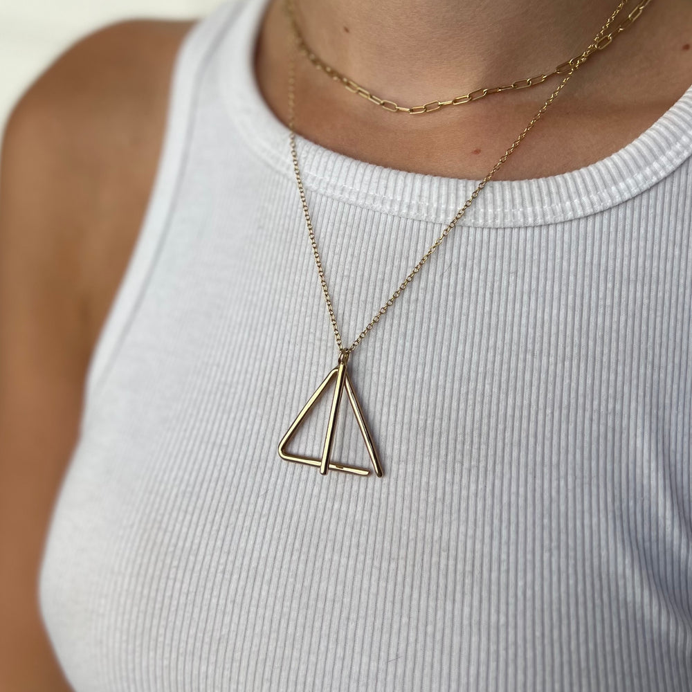 Woman Wearing Handcrafted Triangle Dinner Bell Pendant Necklace