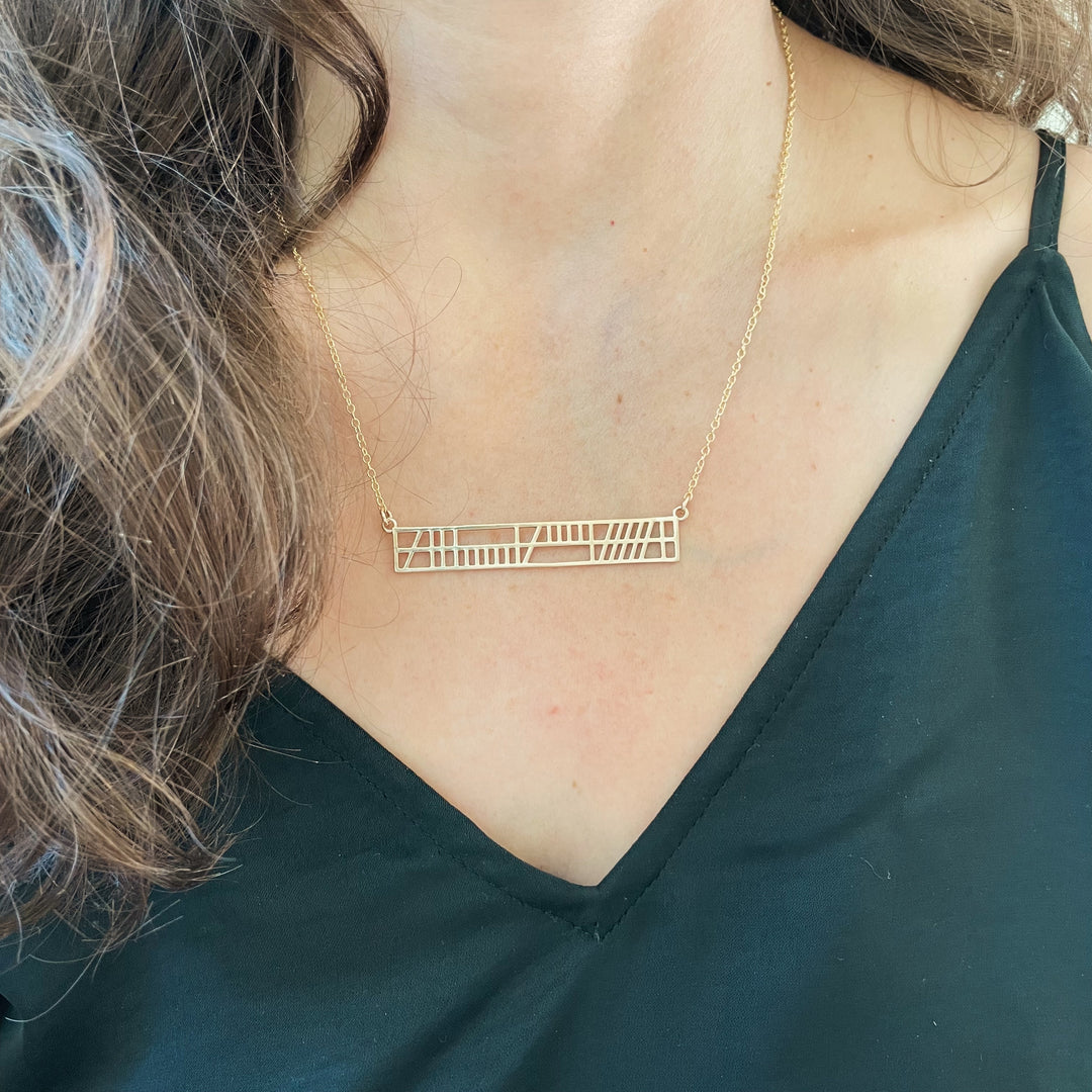 Woman Wearing Handcrafted Bronze Best Friend Bar Necklace