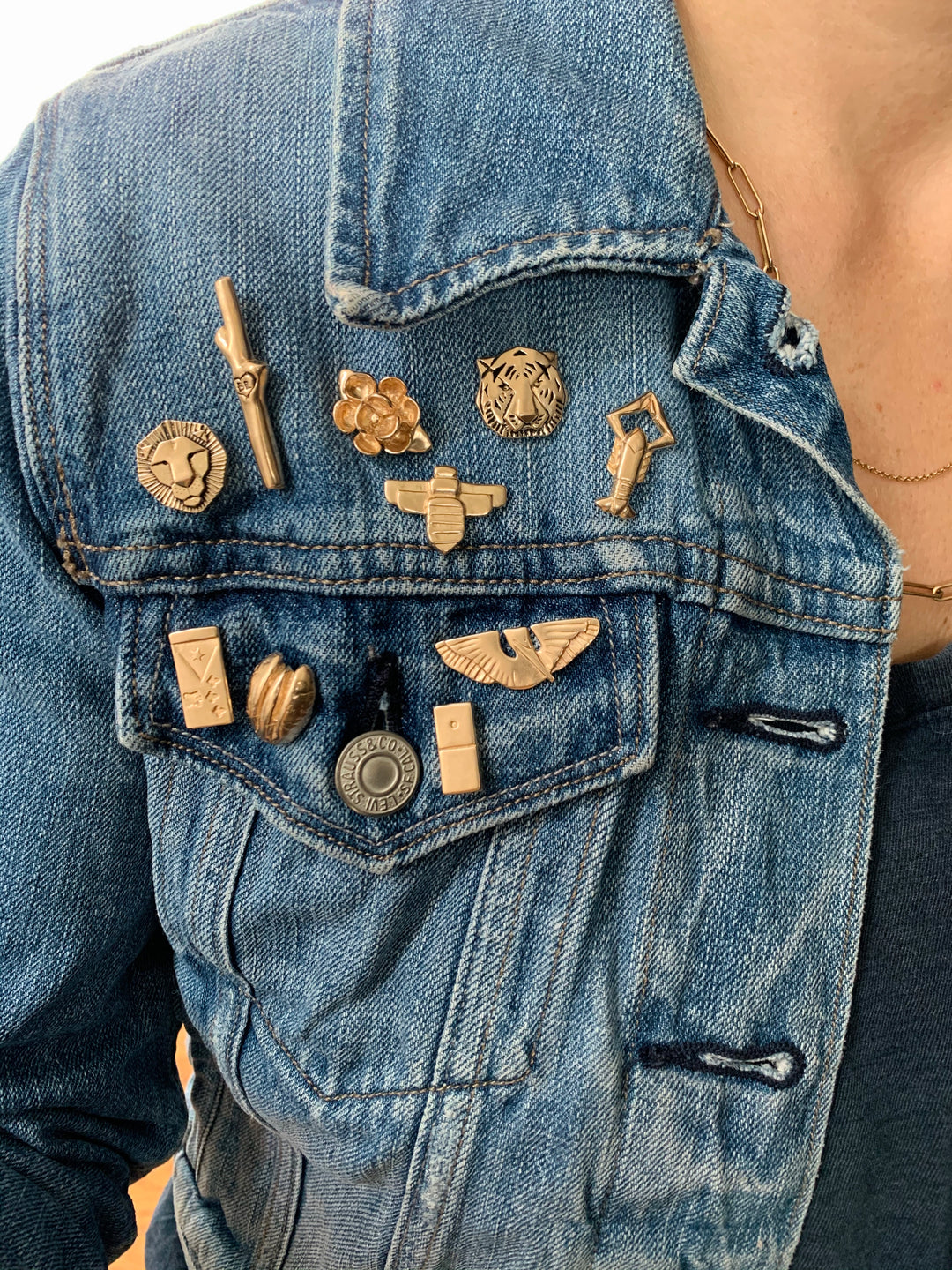 Jean Jacket Displaying Multiple Bronze Tie and Lapel Pins