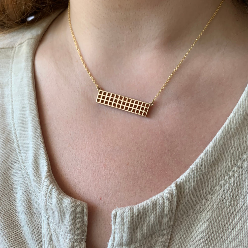 Woman Wearing Handmade Bronze Grid Bar Necklace