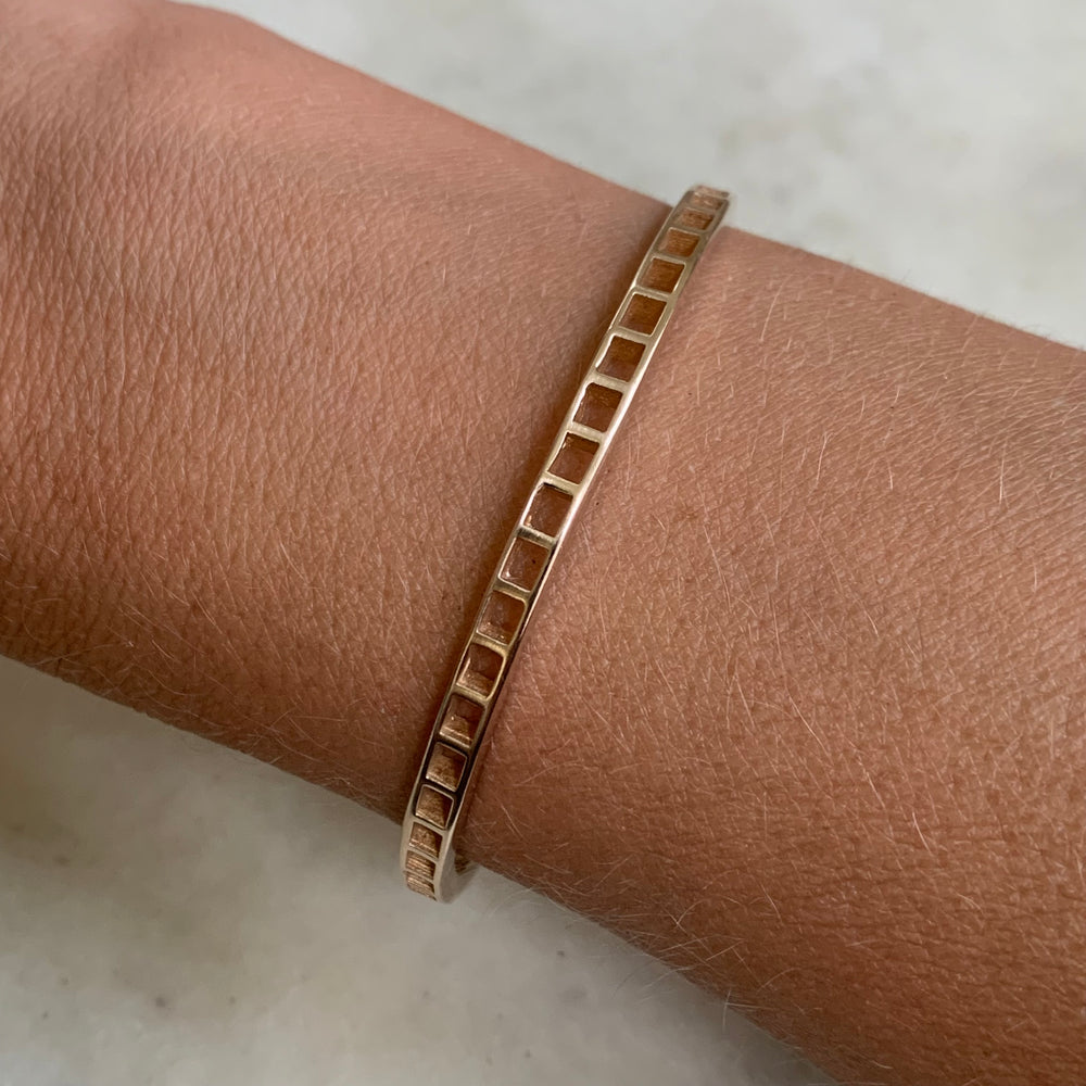 Woman Wearing Handmade Bronze Single Row Grid Cuff Bracelet