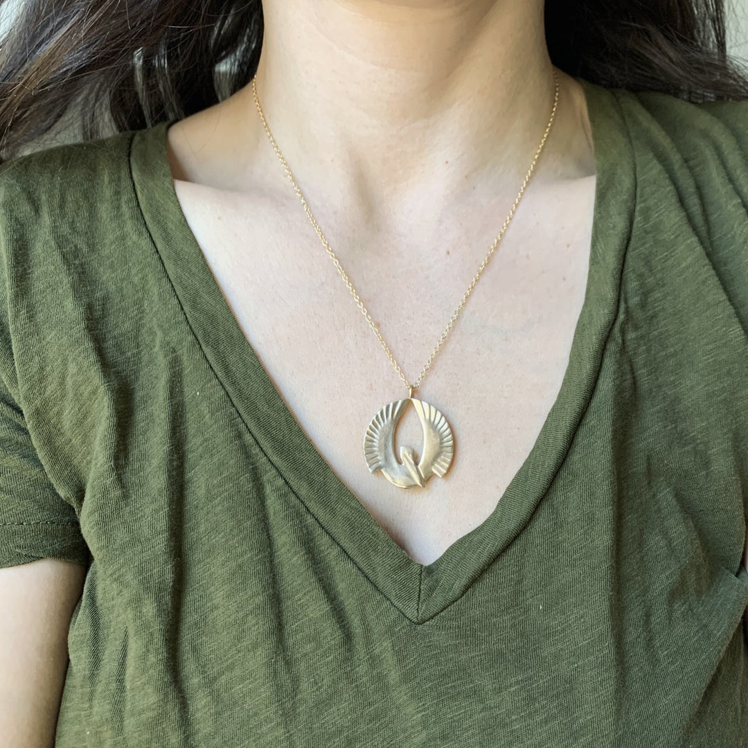 Woman Wearing Handcrafted Bird Pendant Necklace