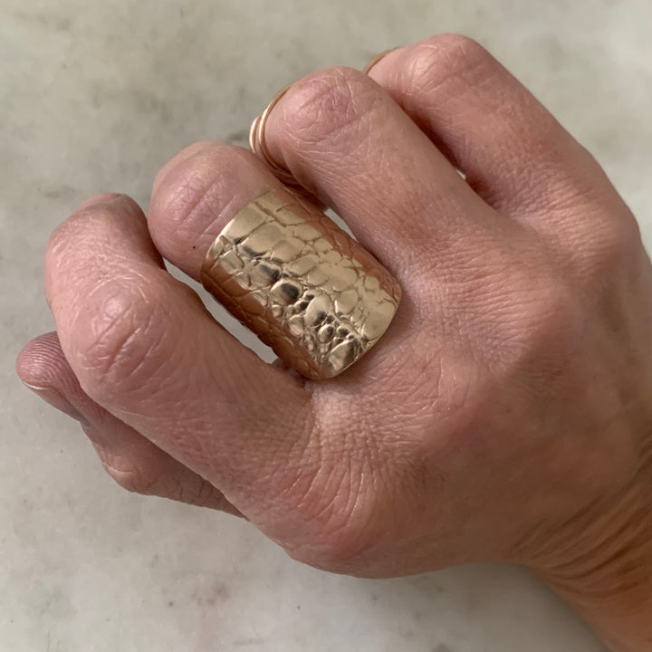 Woman Wearing Handmade Bronze Alligator Skin Ring on middle finger