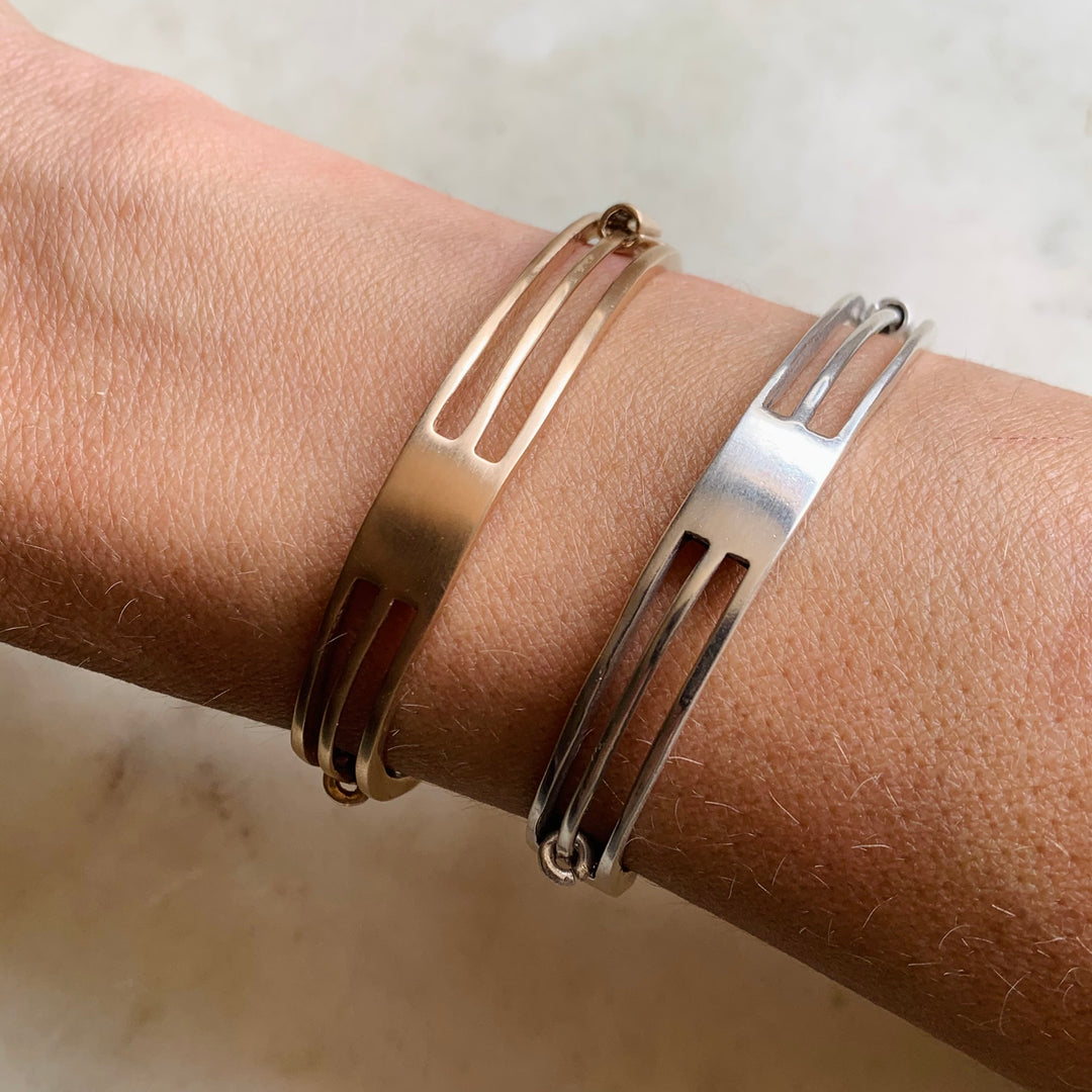 Woman Wearing Handmade Bronze and Sterling Silver Daydreamer Cuff Bracelets with moving parts