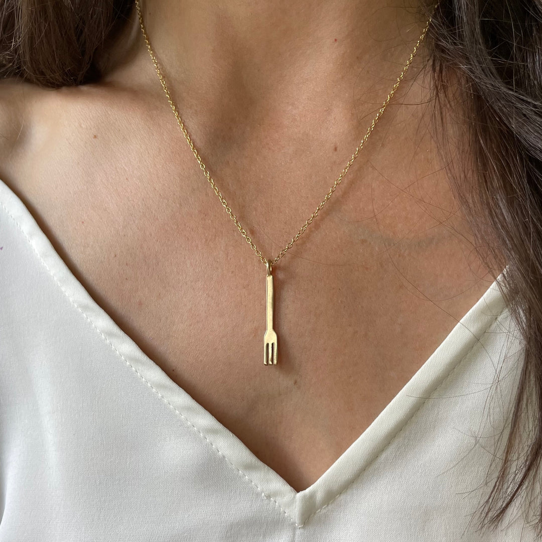 Woman Wearing A Small Bronze Fork Pendant On A Gold-Filled Necklace Chain