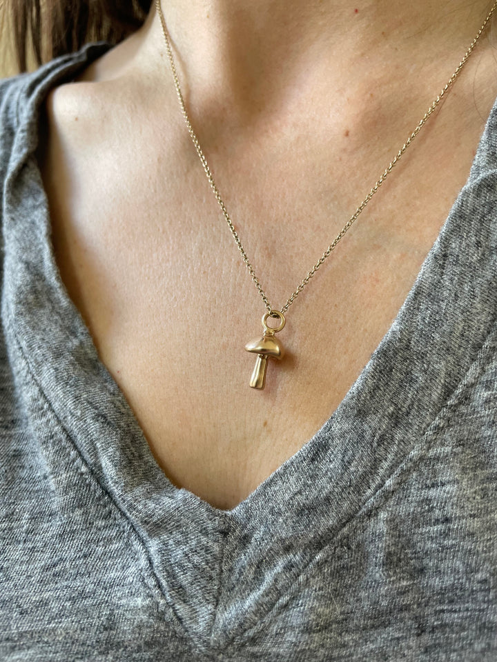 Madeline Wears A MIMOSA Handcrafted Bronze Mushroom Necklace On A Gold-Filled Chain
