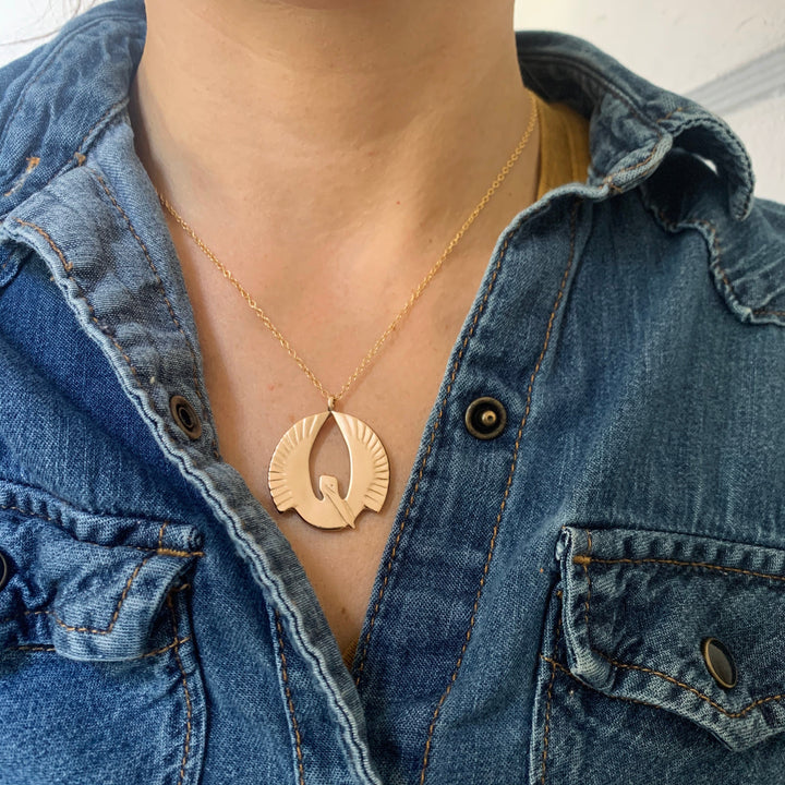 Woman Wearing Handcrafted Pelican Pendant Necklace